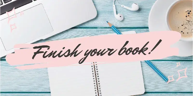 Author writing in notebook at cozy desk